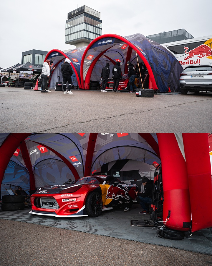 Zaplecze zespołu Jakuba Przygońskiego podczas zawodów Drift Masters w Madrycie oraz czerwony samochód driftingowy ORLEN OIL przygotowywany do rywalizacji